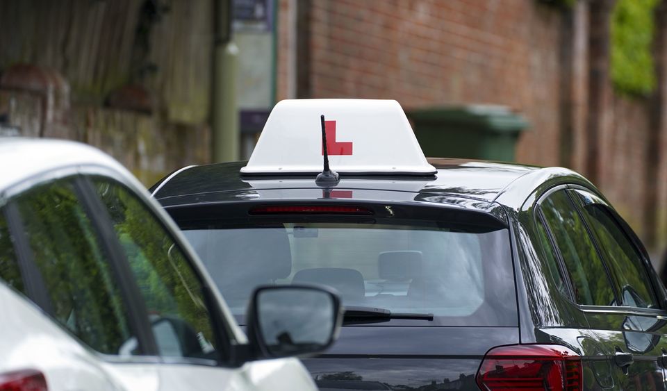 A learner driver drives down a street (Steve Parsons/PA)