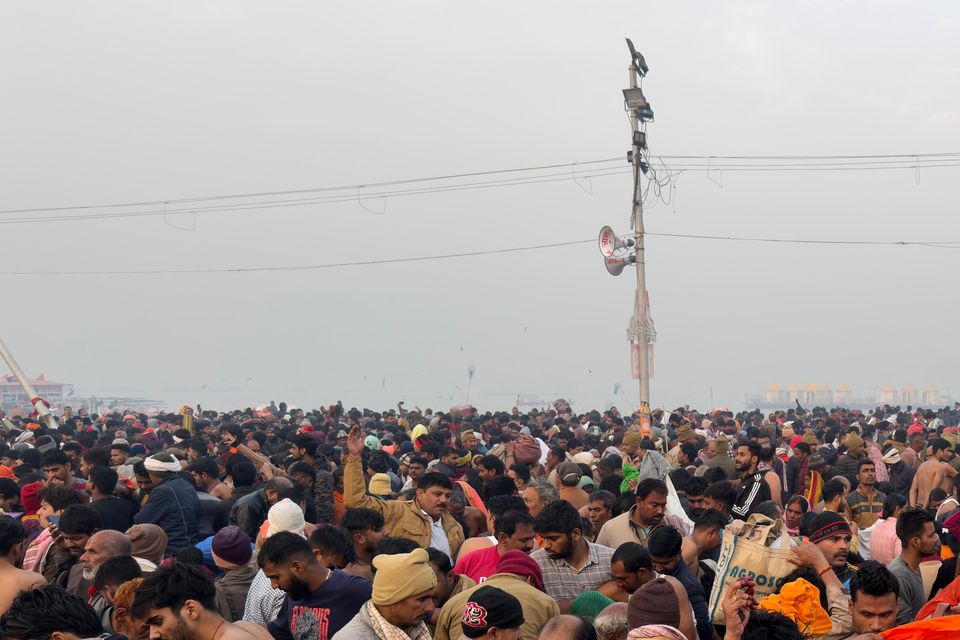 Hindu devotees gather to take a holy dip in the Sangam on Wednesday (Rajesh Kumar Singh/AP)