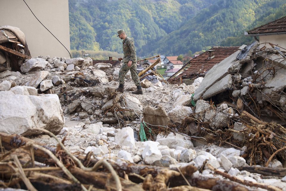 A Bosnian soldier inspects a damaged house after floods and landslides in the village of Donja Jablanica (Armin Durgut/AP)