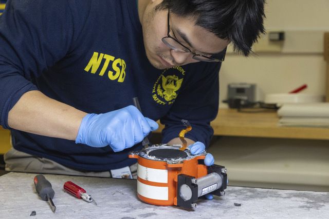 Investigators examine the cockpit voice recorder and flight data recorder recovered from the passenger jet that crashed with an army helicopter (AP)