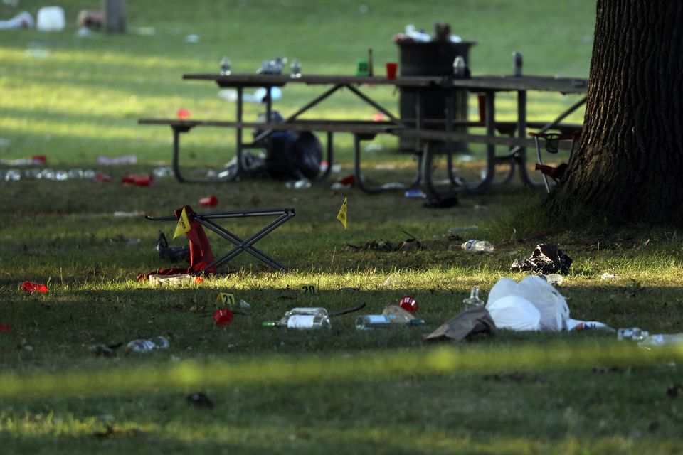 Debris is strewn around evidence markers in an area of Maplewood Park, Rochester, New York (Tina MacIntyre-Yee/AP)