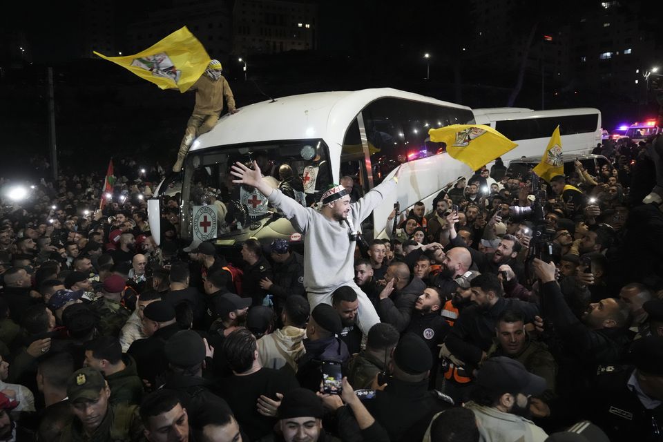 A crowd greets Palestinian prisoners after being released from Israeli prison following a ceasefire agreement between Israel and Hamas (Mahmoud Illean/AP)