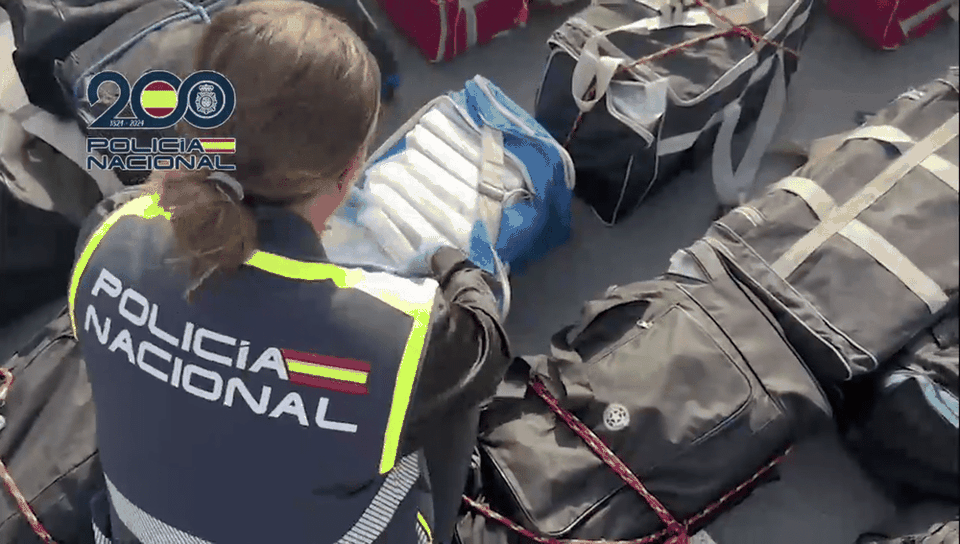 An officer from the Spanish Policia Nacional inspects a drugs shipment seized as part of the operation (NCA/PA)