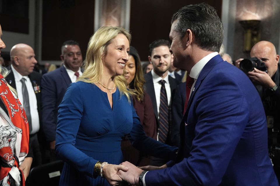 Jennifer Rauchet hugs her husband Pete Hegseth after his Senate Armed Services Committee confirmation hearing (Alex Brandon/AP)