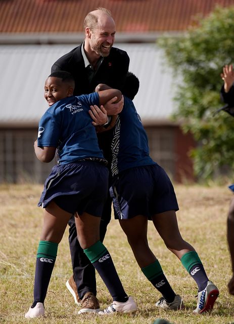 The Prince of Wales takes part in a rugby coaching session with local schoolchildren (Aaron Chown/PA)