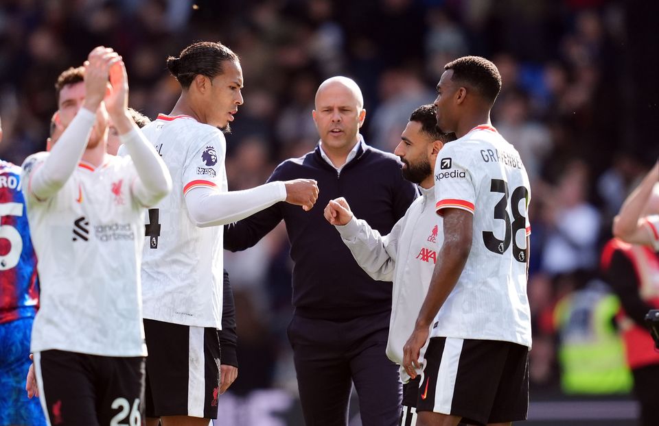 Arne Slot celebrates with his players at the end of the game (Adam Davy/PA)