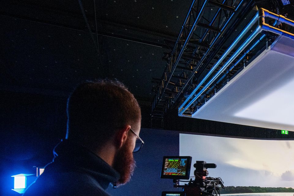 An actor being filmed before a large screen inside the new studio (Abertay University/PA)