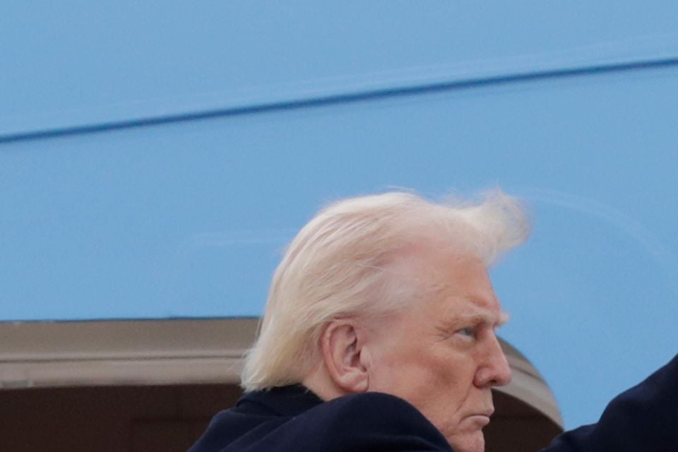 US President Donald Trump gestures from the steps of Air Force One (Luis M Alvarez/AP)