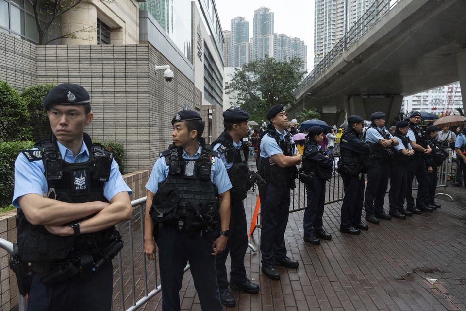 Police officers stood guard outside the Hong Kong court (Chan Long Hei/AP)