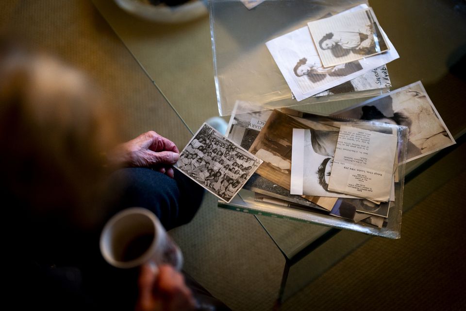 Holocaust survivor Susan Pollack with old photographs and documents from her youth (Jordan Pettitt/PA)