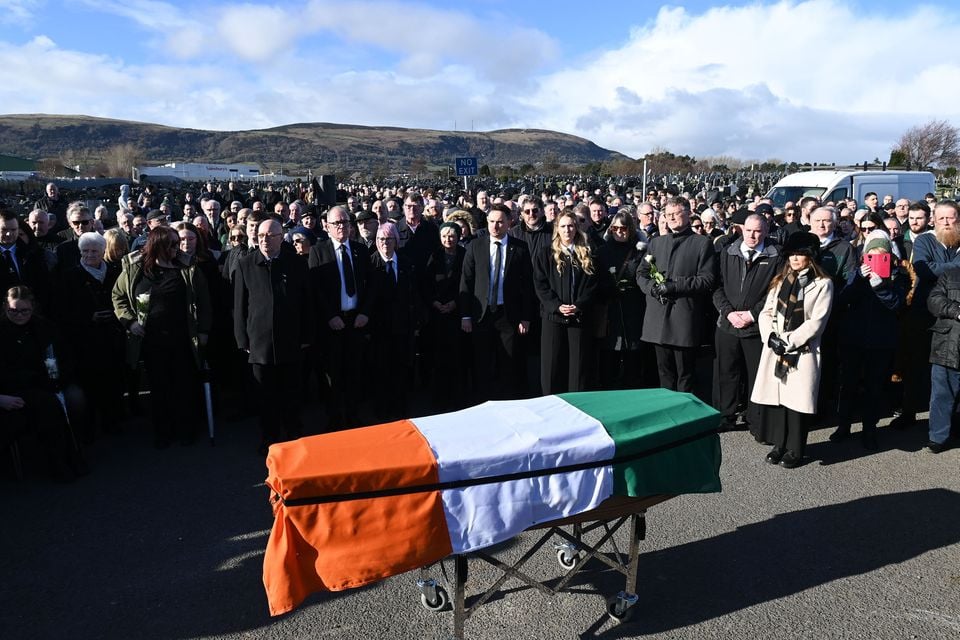 Mourners gather around the coffin of former senior IRA member Brendan McFarlane at the Milltown cemetery for his funeral on February 25, 2025 in Belfast. (Photo by Charles McQuillan/Getty Images)