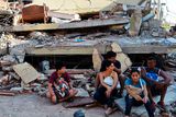 thumbnail: People rest in front of a destroyed house in Manta, Ecuador, on April 17, 2016 a day after a powerful 7.8-magnitude quake hit the country.
The toll from the big earthquake in Ecuador rose on Sunday to 246 dead and 2,527 people injured, the country's vice president said. / AFP PHOTO / LUIS ACOSTALUIS ACOSTA/AFP/Getty Images