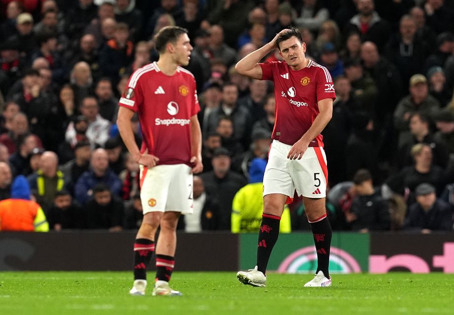 Harry Maguire, right, looks frustrated after Twente’s Sam Lammers equalises (Martin Rickett/PA)