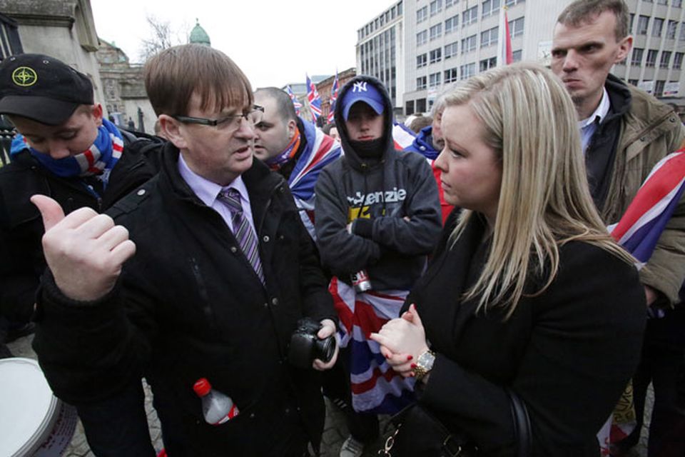 Willie Frazer talks to Sara Girvin as loyalist protestors converge on Belfast city hall. Picture date: Saturday January 5, 2013