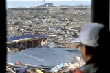thumbnail: A man watches a coastal area from a building where he took shelter in Tamura, Iwate, northern Japan as tsunami warning was issued Monday, March 14, 2011 following Friday's massive earthquake and the ensuing tsunami. (AP Photo/Kyodo News)  JAPAN OUT, MANDATORY CREDIT, NO SALES IN CHINA, HONG  KONG, JAPAN, SOUTH KOREA AND FRANCE