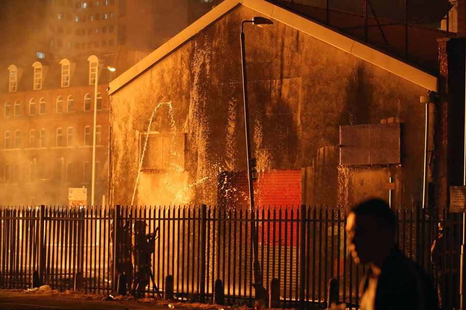 Press Eye - Belfast - Northern Ireland - 11th July  2018 

General view fire officers cooling down a building at the  Hope Street bonfire at Sandy Row in South Belfast.

It comes after the PSNI issued a notice informing the public that paramilitaries intend to orchestrate serious disorder against police officers on the Eleventh night.

Photo by Kelvin Boyes / Press Eye.