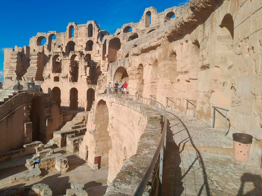 Visitors are dwarfed by the scale of the amphitheatre, still largely intact at El Jem in Tunisia