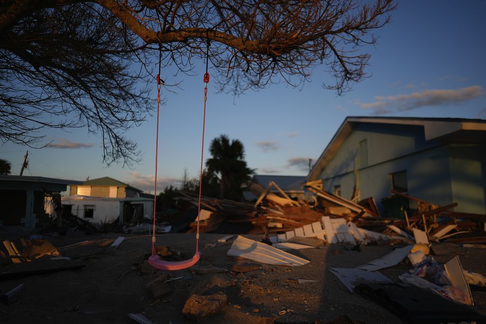 A child’s swing still hangs on a tree, surrounded by debris from homes destroyed by Hurricane Milton (AP/Rebecca Blackwell)