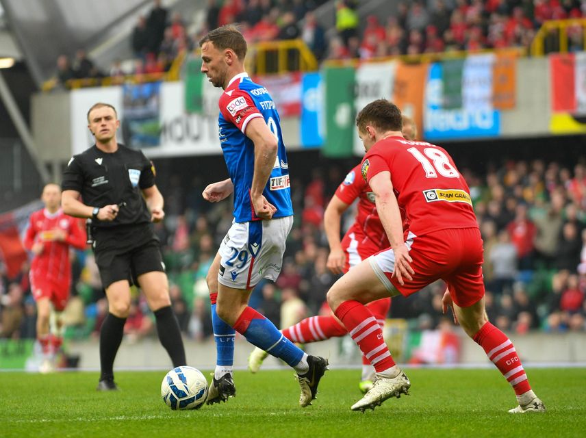 Cliftonville defender Paddy Burns closes down Linfield striker Matthew Fitzpatrick during the Irish Cup Final
