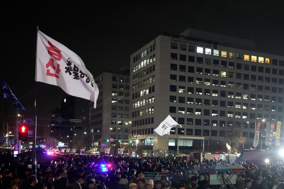 People gather in front of the National Assembly in Seoul (Ahn Young-joon/AP)