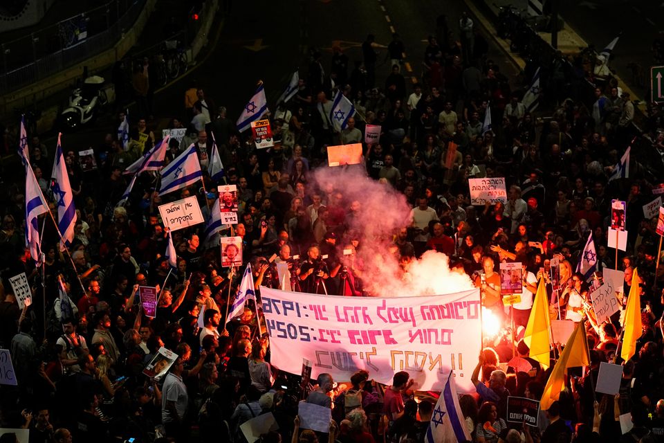 Israeli demonstrators block a road in Tel Aviv (Ariel Schalit/AP)