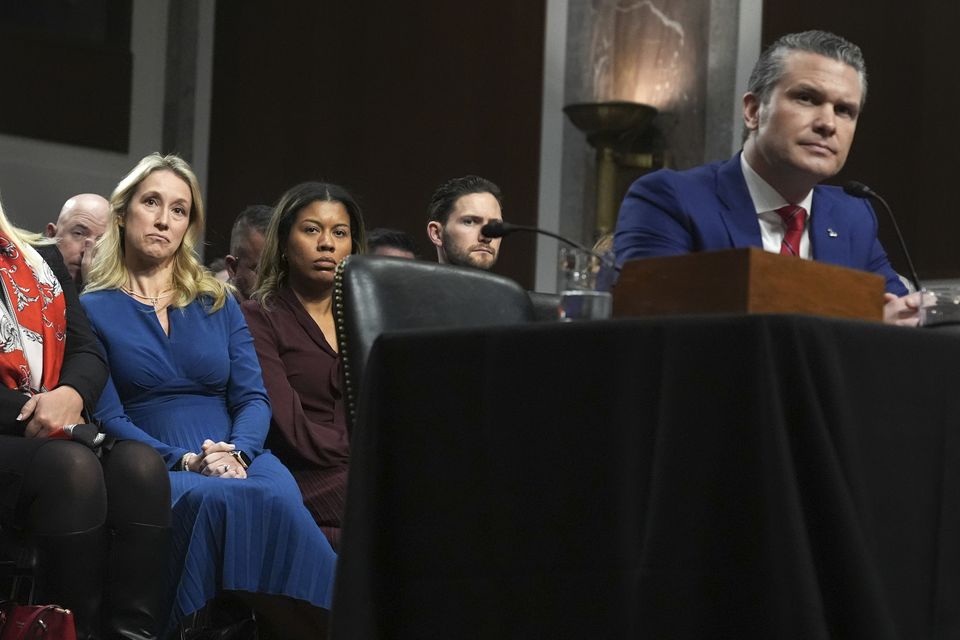 Jennifer Rauchet, left, listens as her husband Pete Hegseth, right, appears before the Senate Armed Services Committee (Jacquelyn Martin/AP)