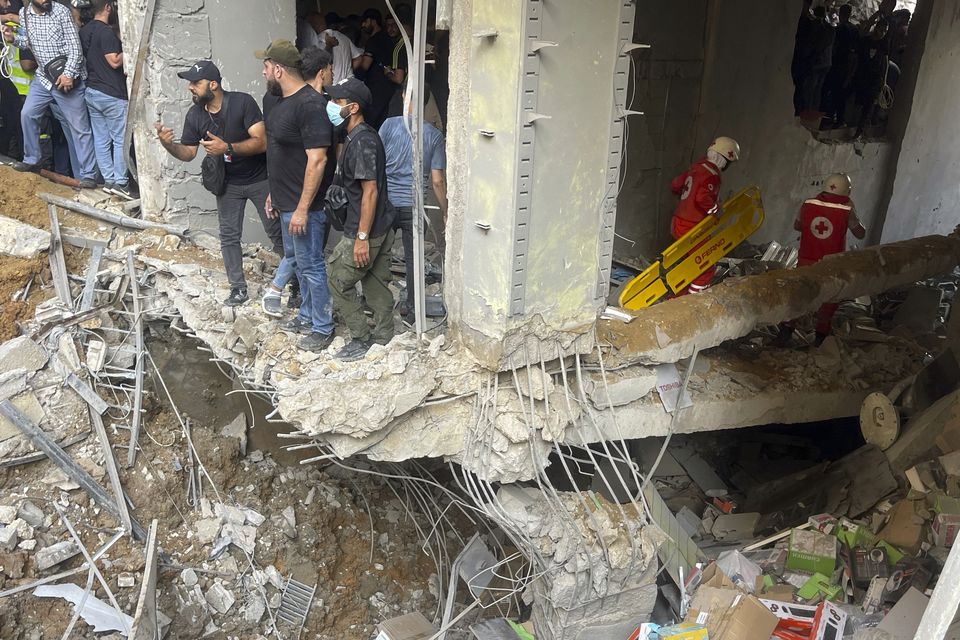 Rescuers at the scene of another Beirut missile strike (Bilal Hussein/AP)