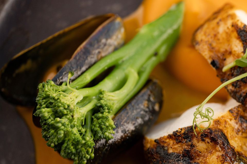 Monkfish tail with blackened spices, curried mussel cream, butternut squash puree and tenderstem broccoli