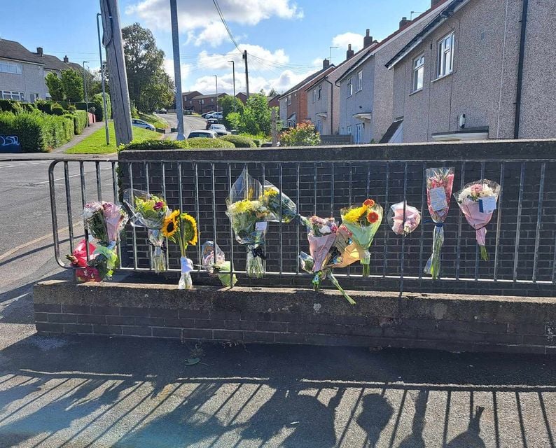 Floral tributes left the scene he scene in Heights Drive, Wortley (Matt Gibson/PA)