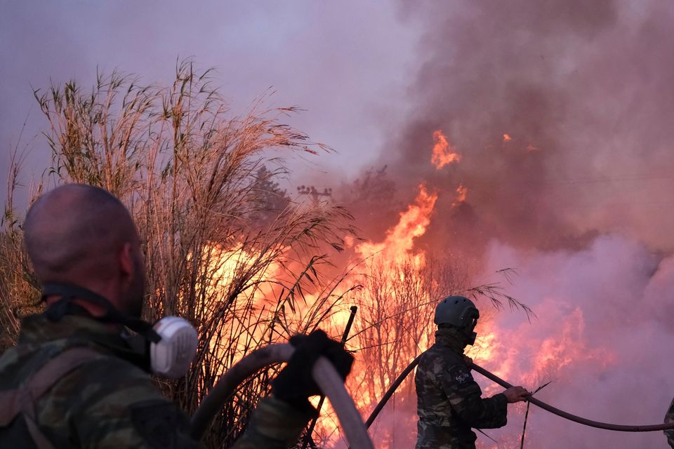 The wildfire raced through pine forests left tinder-dry by repeated heatwaves this summer (Aggelos Barai/AP)