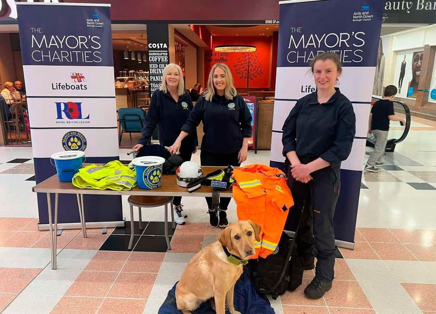 K9SARNI Chair Joanne Dorrian (centre), treasurer Don Allen (left) and dog handler Shauna Harper with search and rescue dog Koda