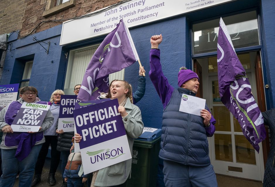 Unison members on strike staged a demo outside the First Minister’s office (Jane Barlow/PA)