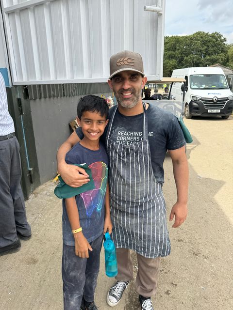 Faraz Sethi with his son, Zachariah Sethi, outside the on-site roti plant at the Jalsa Salana (Sabah Ahmedi/PA)