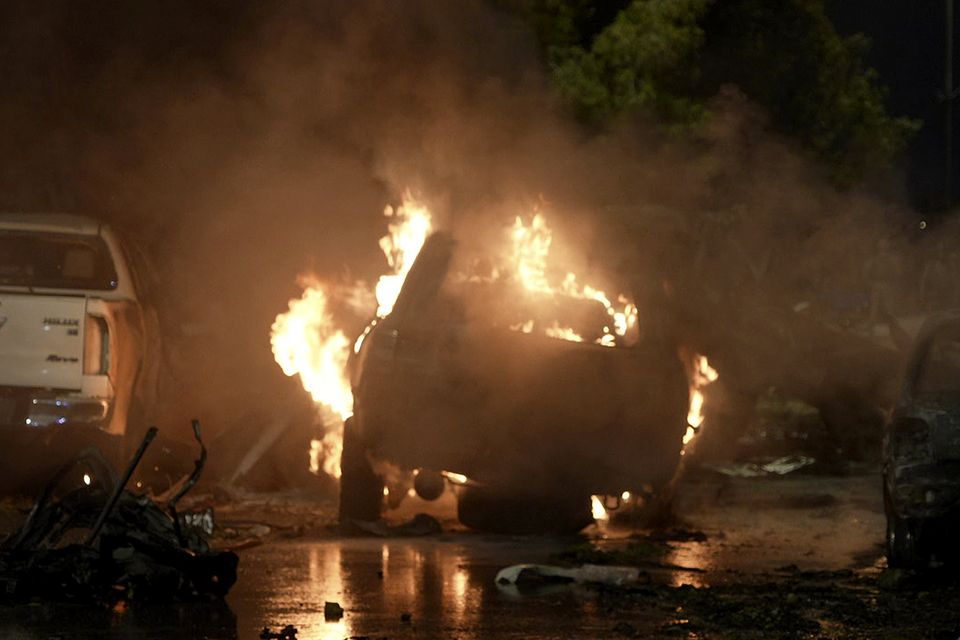 A vehicle on fire at the site of the explosion (Mohammad Farooq/AP)