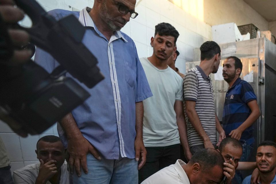 Palestinians mourn the victims of an Israeli airstrike in Deir al Balah (Abdel Kareem Hana/AP)