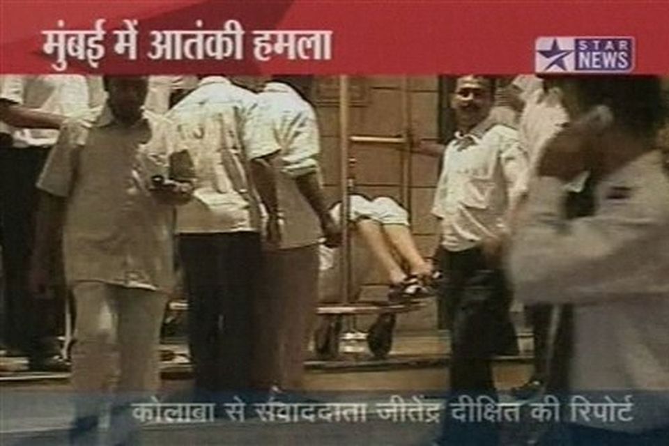 An injured man lies on a hotel's baggage trolley in Mumbai, India in this image made from television, Wednesday, Nov. 26, 2008. Gunmen targeted luxury hotels, a popular tourist attraction and a crowded train station in at least seven attacks in India's financial capital Wednesday, wounding 25 people, police and witnesses said. A.N Roy police commissioner of Maharashtra state, of which Mumbai is the capital, said several people had been wounded in the attacks and police were battling the gunmen. "The terrorists have used automatic weapons and in some places grenades have been lobbed," said Roy. Gunmen opened fire on two of the city's best known Luxury hotels, the Taj Mahal and the Oberoi. They also attacked the crowded Chhatrapati Shivaji Terminus station in southern Mumbai and Leopold's restaurant, a Mumbai landmark. It was not immediately clear what the motive was for the attacks.  (AP Photo/STAR NEWS)  **  INDIA OUT  TV OUT  **