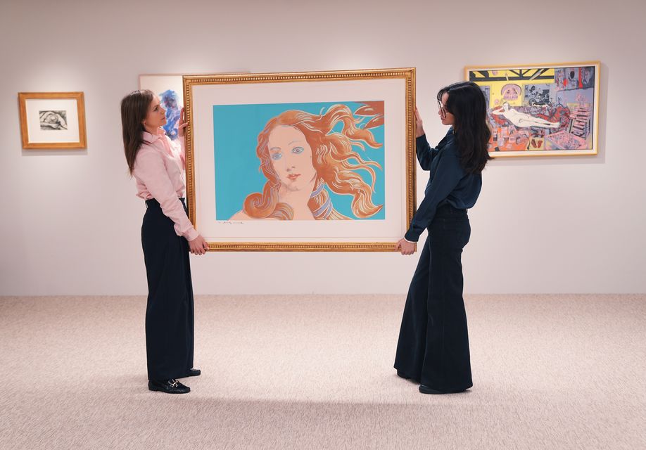 Gallery staff holding a piece by Andy Warhol (Yui Mok/PA)