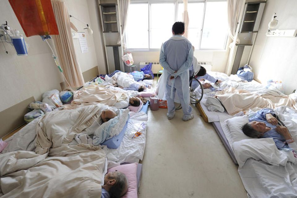 CORRECTS WHOLE CAPTION - Patients at a hospital wait to be evacuated without medicine and electricity in Otsuchi in Iwate Prefecture (state) Sunday, March 13, 2011, two days after a strong earthquake and tsunami hit northeastern Japan. (AP Photo/The Yomiuri Shimbun, Yasuhiro Takami)  JAPAN OUT, CREDIT MANDATORY