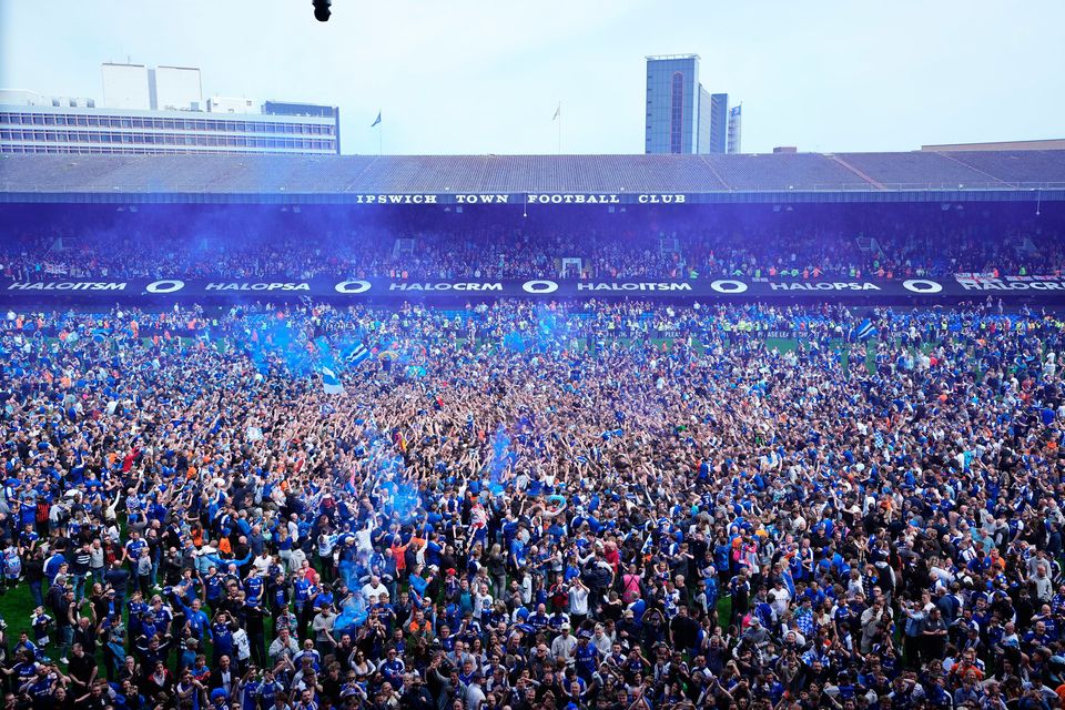 Fans on the pitch at Portman Road after Ipswich secured promotion.