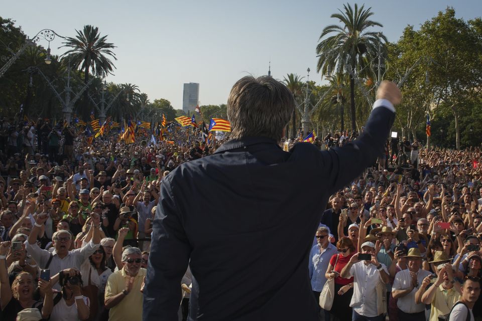 Catalan independence leader Carles Puigdemont addresses supporters near the Catalan parliament in Barcelona on Thursday (Emilio Morenatti/AP)