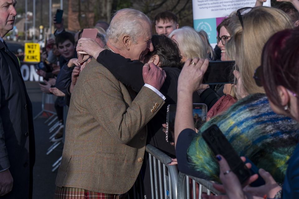 The King received a hug from one well-wisher during his walkabout (Jane Barlow/PA)