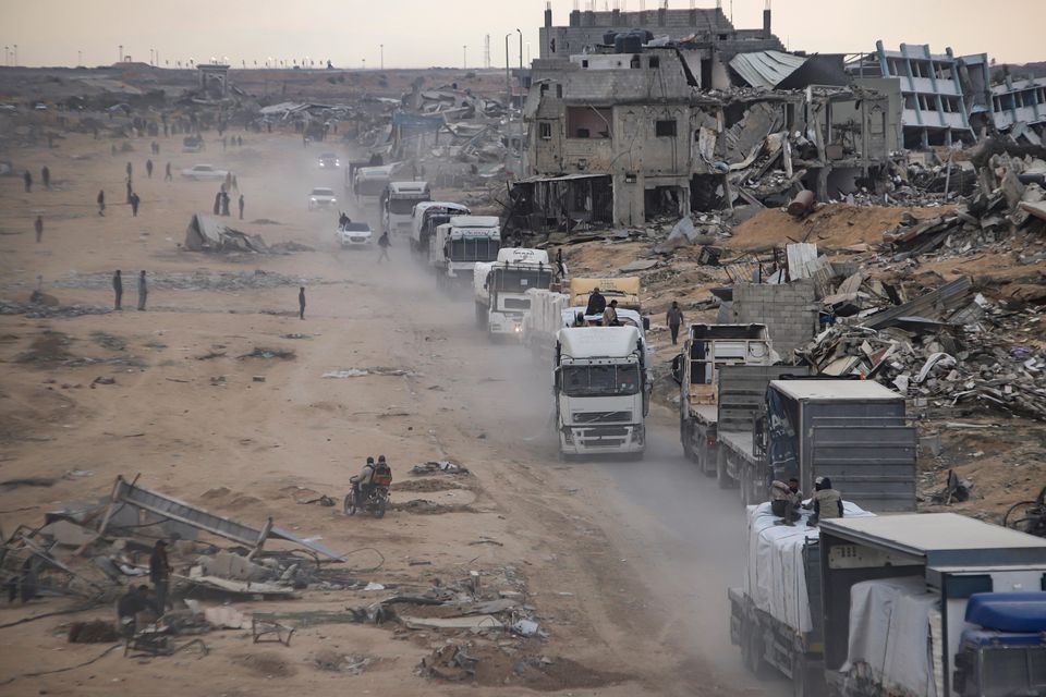 Humanitarian aid trucks enter through the Kerem Shalom crossing from Egypt into the Gaza Strip, in Rafah, on Wednesday (Jehad Alshrafi/AP)