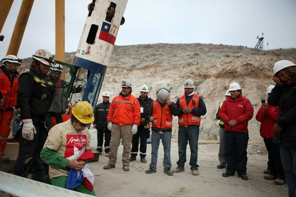 SAN JOSE MINE, CHILE - OCTOBER 13: (NO SALES, NO ARCHIVE) In this handout from the Chilean government, the oldest rescued miner Claudio Mario Gomez, 59, kneels as he becomes the ninth to exit the rescue capsule, on October 13, 2010 at the San Jose mine near Copiapo, Chile. The rescue operation has begun bringing up the 33 miners, 69 days after the August 5, 2010 collapse that trapped them half a mile underground. (Photo by Hugo Infante/Chilean Government via Getty Images)
