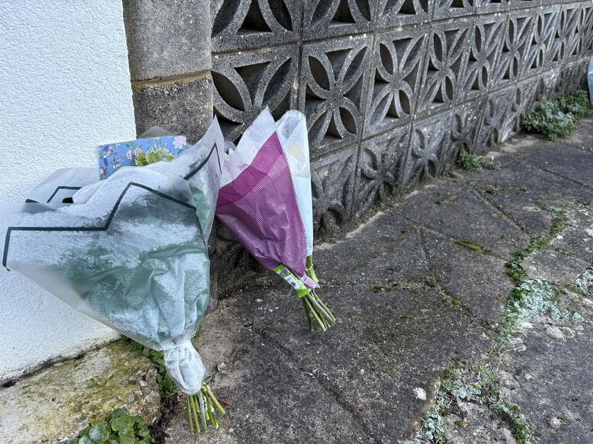 Flowers left on the driveway of a house in Poole, where an elderly couple were found dead (Ben Mitchell/PA)