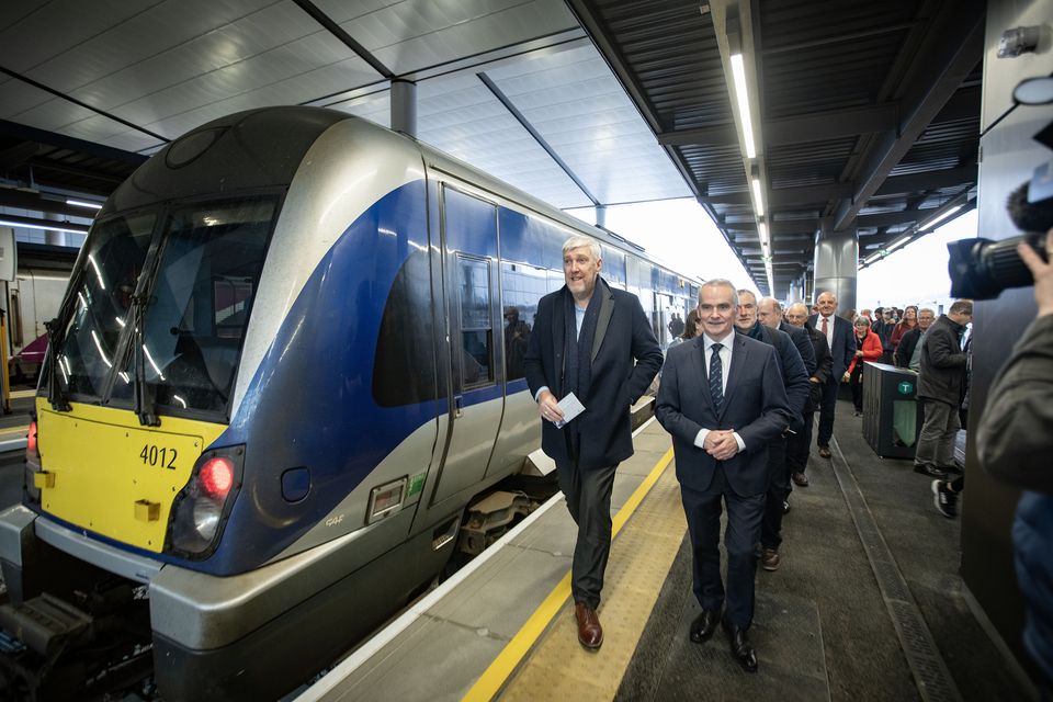 Infrastructure Minister John O'Dowd arrives on one of the first trains into Belfast Grand Central Station  this morning is welcomed by Translink Group Chief Executive Chris Conway. Picture by Brian Morrison.