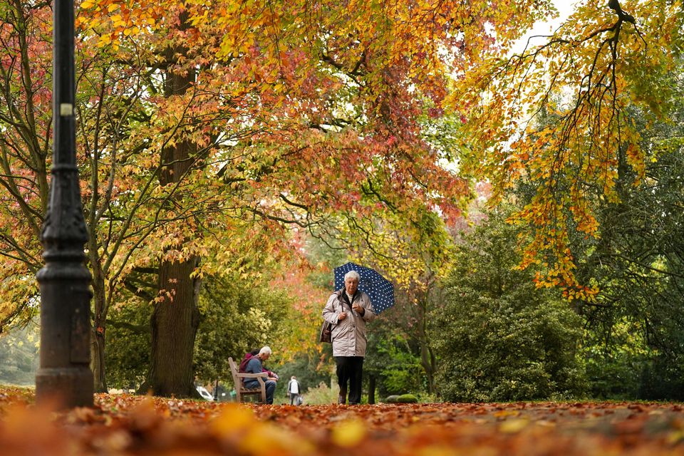 People enjoy a walk through Jephson Gardens in Leamington Spa, Warwickshire, during autumnal weather (Jacob King/PA)