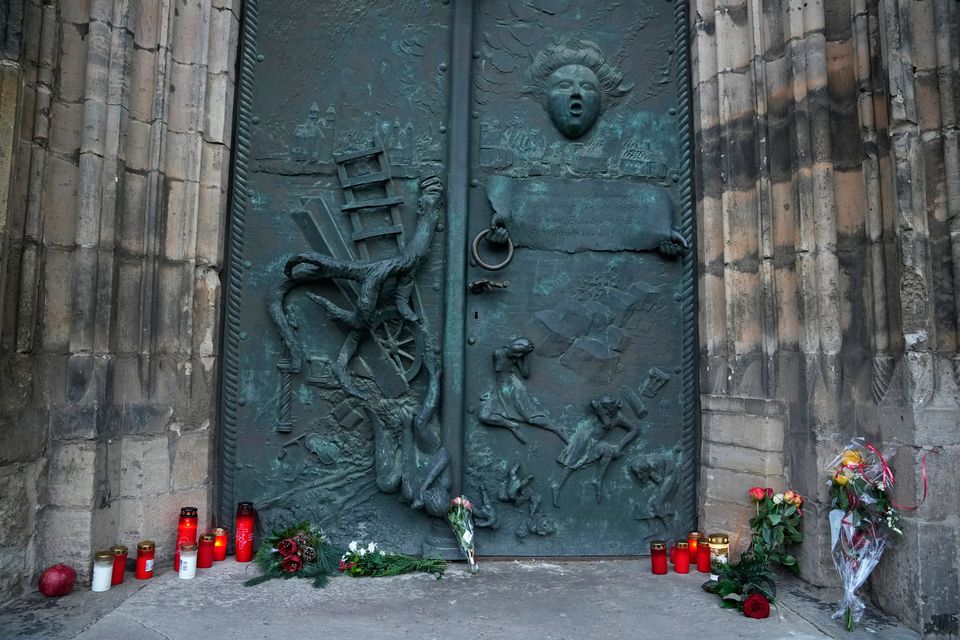 Flowers and candles are placed outside St. John's Church near the Christmas Market. (AP Photo/Ebrahim Noroozi)