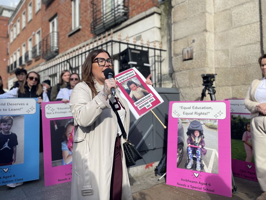 Nicole Hosford holds up a sign of her daughter Libbycrae (PA)