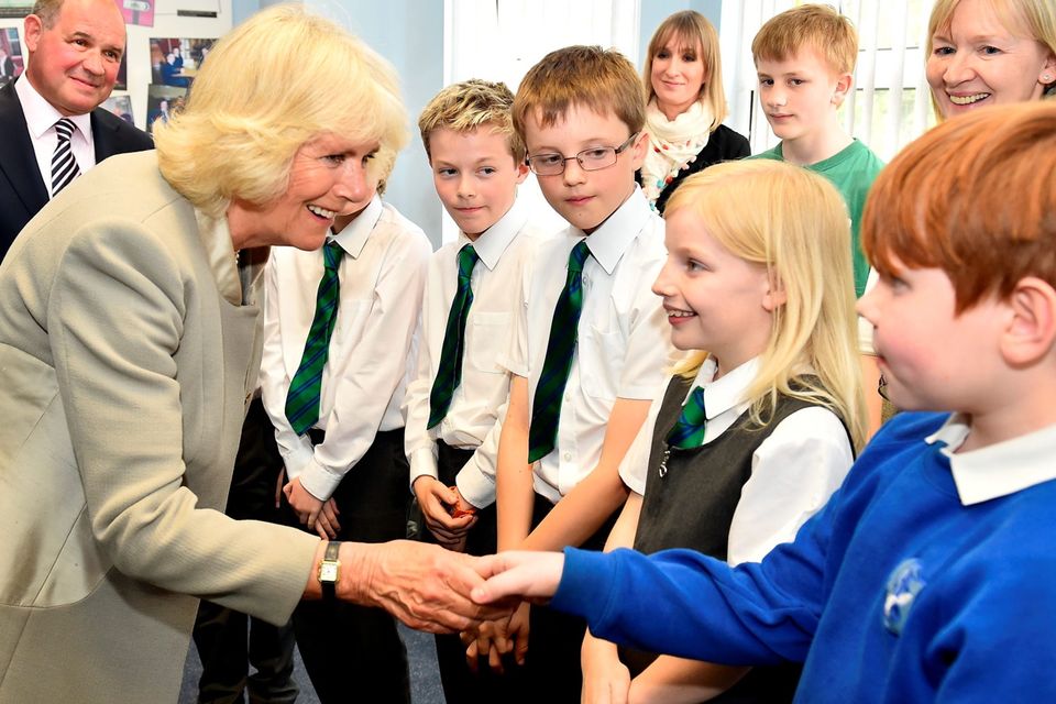 The Duchess of Cornwall meets school children as she visits Ballyhackamore Credit Union in Belfast, Northern Ireland, as the Prince of Wales and Camilla, attend a series of engagements in Northern Ireland following their two day visit in the Republic of Ireland. PRESS ASSOCIATION Photo. Picture date: Thursday May 21, 2015. See PA story ROYAL Ireland. Photo credit should read: Jeff J Mitchell/PA Wire