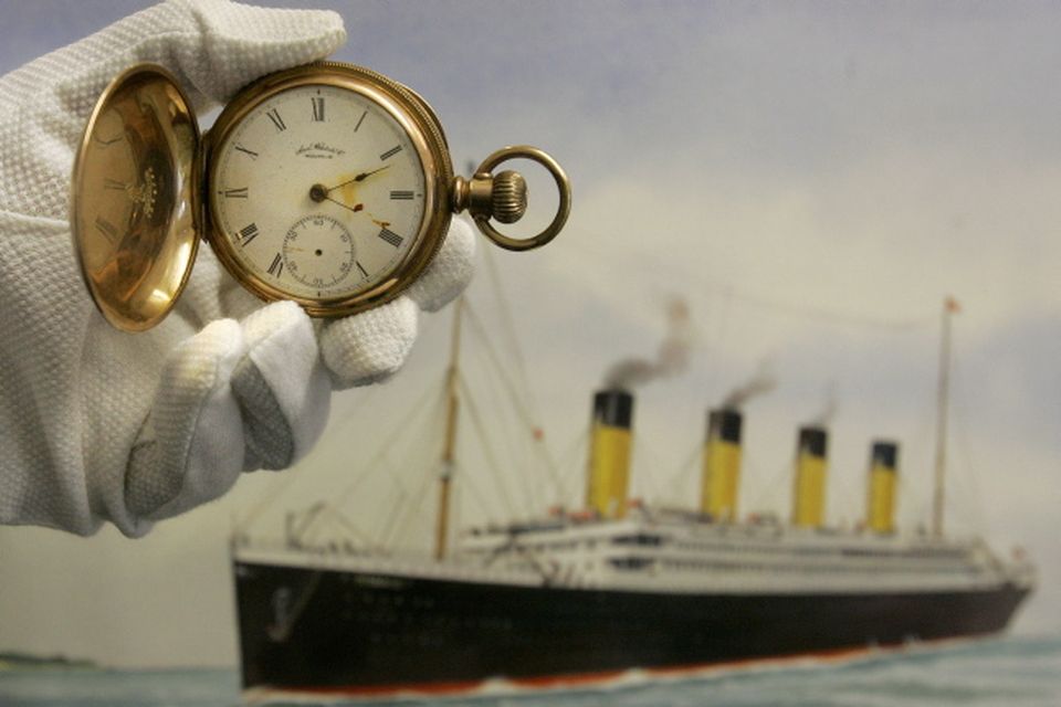 A gold plated Waltham American pocket watch, the property of Carl Asplund, is seen in front of a modern water colour painting of the Titanic by CJ Ashford at Henry Aldridge and Son auctioneers in Devizes, Wiltshire, England Thursday, April 3, 2008. The locket and one of the rings were recovered from the body of Carl Asplund who drowned on the Titanic, they are all part of the Lillian Asplund collection of Titanic related items.